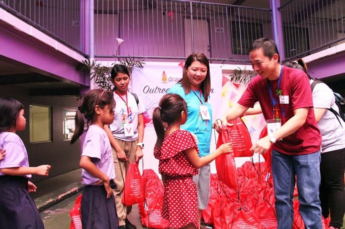 Dragonpay COO Robertson Chiang giving gifts to children